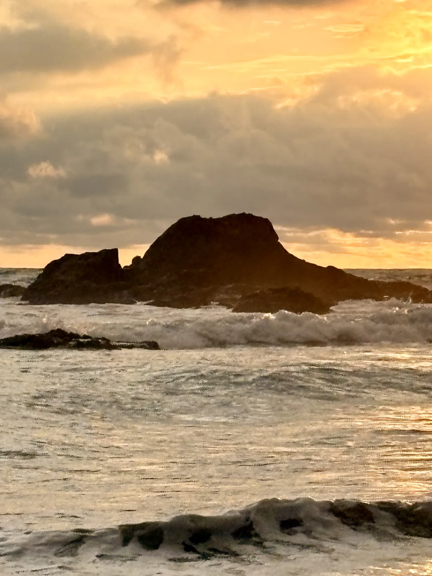 Waves breaking on the rocks at golden hour