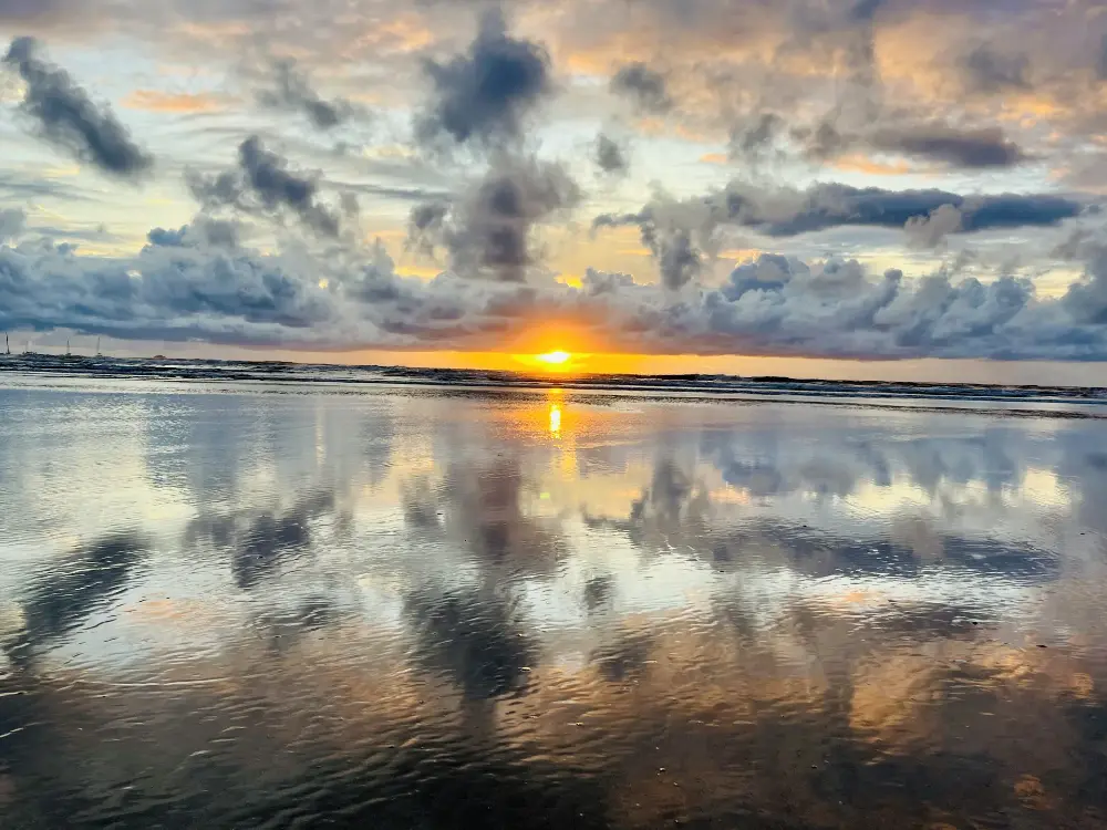 Cloud mirror with the sun on the horizon